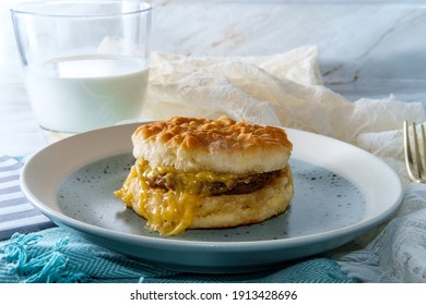 Sausage Egg And Cheese Biscuit Breakfast Sandwich With Glass Of Milk