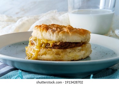 Sausage Egg And Cheese Biscuit Breakfast Sandwich With Glass Of Milk