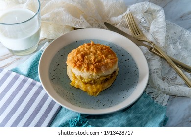 Sausage Egg And Cheese Biscuit Breakfast Sandwich With Glass Of Milk