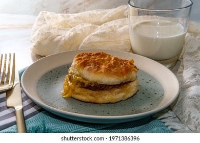 Sausage Egg And Cheese Biscuit Breakfast Sandwich With Glass Of Milk