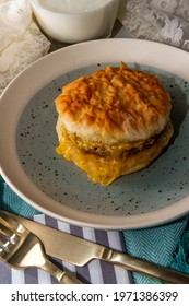 Sausage Egg And Cheese Biscuit Breakfast Sandwich With Glass Of Milk