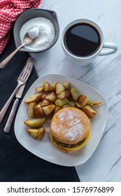 Sausage Egg And Cheese Breakfast Sandwich On An English Muffin With Home Fries And Coffee