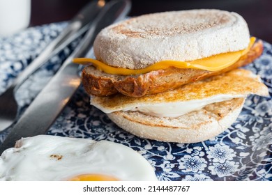 Sausage, Egg And Cheese Muffin On A Blue Plate.