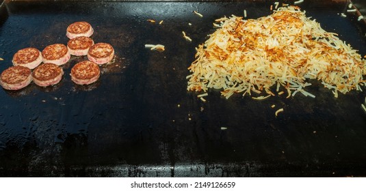 Sausage And Hash Browns Cooking On The Black Stone Griddle