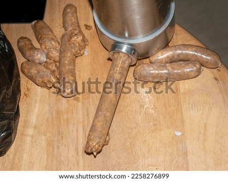 Sausage making machine pipe full of sausage meat , sausage pieces around 