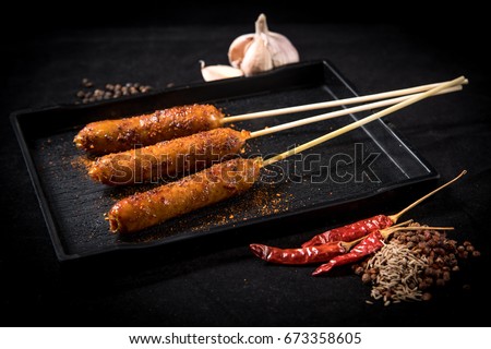 sausage mala grilled on table with blackground (selective focusing)