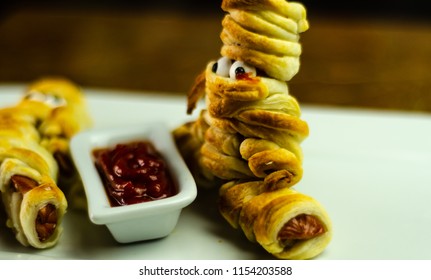 Sausage mummies in dough scary halloween food celebration party with funny eyes, food for kids