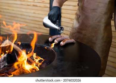 Sausage On Barbeque Smoker Grill. Hot And Smoked Sausage. Food Festival