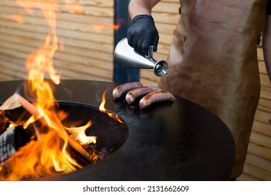 Sausage On Barbeque Smoker Grill. Hot And Smoked Sausage. Food Festival