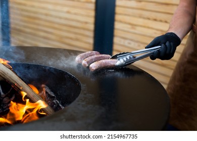 Sausage On Barbeque Smoker Grill. Hot And Smoked Sausage. Food Festival