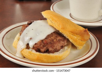 A Sausage Patty On A Fresh Baked Biscuit With Country Gravy