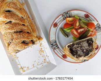 Sausage Plait With Black Pudding On A White Background