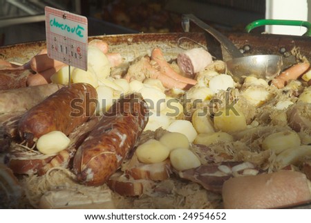 Sausage, sauerkraut and potatoes (choucroute) for sale in french market.  Close-up.