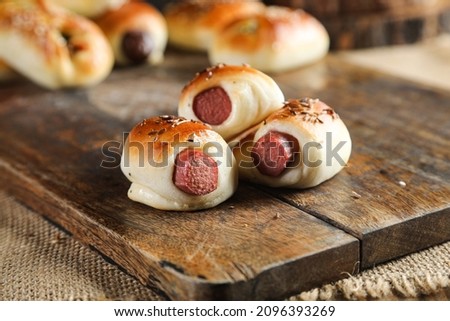 Sausage snack roll on cutting board 