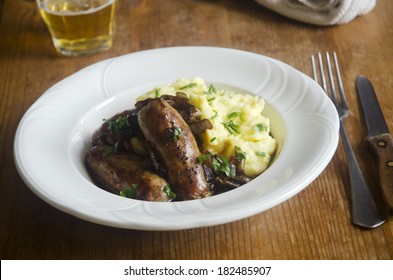 Sausages With Herby Mash And Onion Gravy