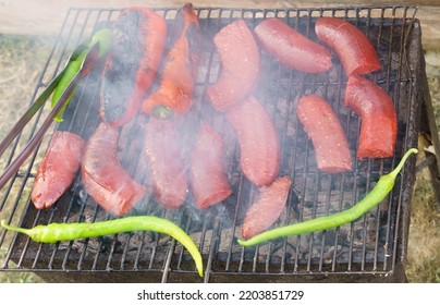 Sausages On Barbecue Grill Fire Smoke.