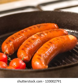 sausages and tomatoes on grilling pan