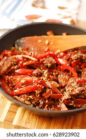 Sauteed beef with red chili in black pan - Shutterstock ID 628923902
