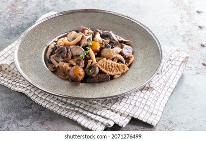 Sauteed Wild Mushrooms - Mushrooms Ragout cooked in a White Wine Served in a Metal Plate - Powered by Shutterstock