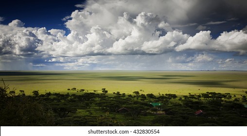 Savanna Landscape In Serengeti National Park, Tanzania, With A Cloudy Sky Panorama