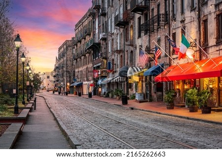 Savannah, Georgia, USA bars and restaurants on River Street at dawn.