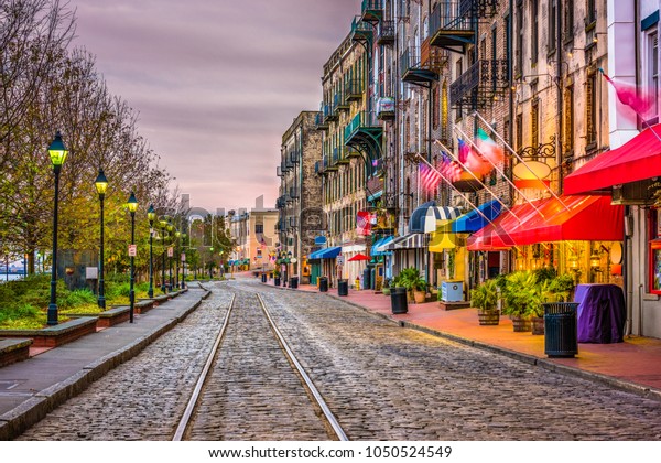 Savannah, Georgia, USA bars and restaurants on\
River Street.