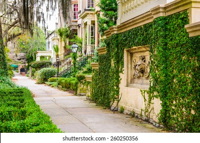 Savannah, Georgia, USA historic downtown sidewalks and rowhouses.