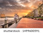 Savannah, Georgia, USA riverfront promenade at sunrise.