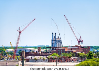 Savannah River Waterfront With Construction Real Estate Development Site By Cranes And Brick Old Town Architecture In Savannah, Georgia Southern City