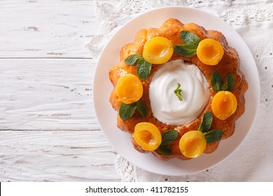 Savarin French Dessert With Apricots And Whipped Cream. Vertical View From Above
