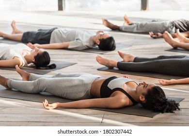 Savasana Pose. Diverse Yoga Class Members Meditating On Floor, Lying On Mats In Studio During Group Training, Free Space