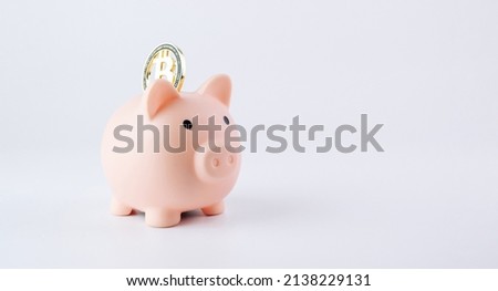Save currency bitcoin. Pink pig bank with golden bit coin money BTC on white background. Save money investment and business finance