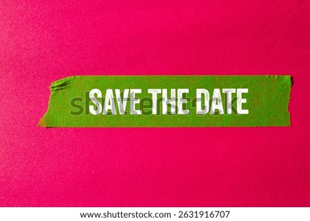 Save the date message written on ripped torn green paper tape on pink background. Conceptual save the date symbol. Copy space.