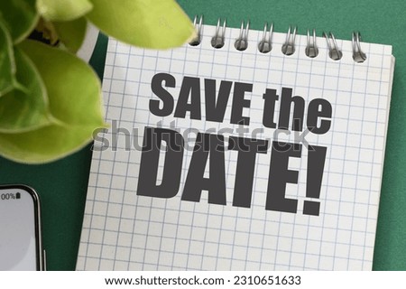 SAVE THE DATE words in an office notebook.