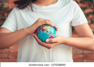 Save The Earth and Care Environment Concept, Close-up of Woman Hands is Holding Mockup Global in Her Hands For Eco Living. Save The Planet Earth and Caring Ecology Environmental For Sustainable
