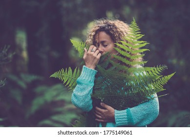 Save The Earth Planet And Celebrate Earth's Day With Adult Woman Hug And Hold A Green Leaf In The Forest Wood Enjoying Nature - Stop Deforestation Concept With People Love Nature