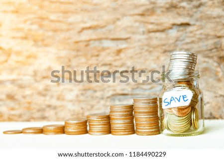 Save Money concept, Coins in glass jar for money saving financial concept.