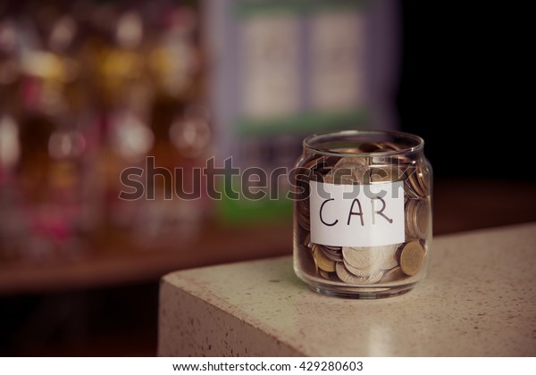 save money.save money concept.save money in glass\
money jar with car label.