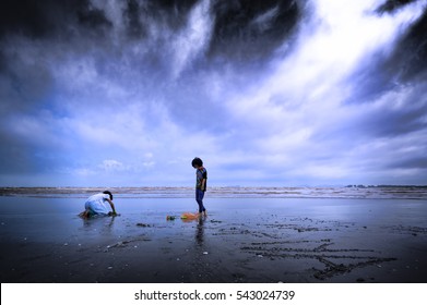 Save Our World And Environmental Concept. Kids Playing At Beach During Cloudy Sky In Monsoon With Vignette And Haze Effect.