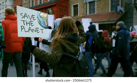 Save planet ecology protest outdoor. Activist person hold anti global warming banner. Eco demonstration placard. No climate change concept. City street picket background. World care rally Earth poster - Powered by Shutterstock