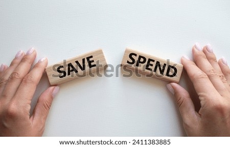 Save or Spend symbol. Concept word Save or Spend on wooden blocks. Businessman hand. Beautiful white background. Business and Save or Spend concept. Copy space