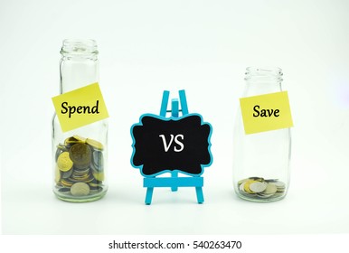 Save vs Spend text written on glass jar. Business or Financial concept.