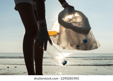 Save water. Volunteer pick up trash garbage at the beach and plastic bottles are difficult decompose prevent harm aquatic life. Earth, Environment, Greening planet, reduce global warming, Save world - Powered by Shutterstock