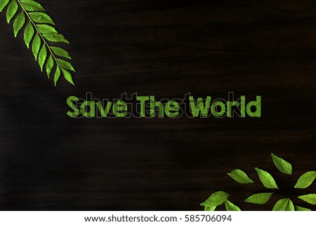 Save the world text with green leaf with water drop on black background