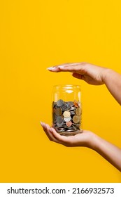 Save your money and money in a glass jar with coins inside. enhance savings The concept of planting a money saving plan and saving expenses increases more income. - Shutterstock ID 2166932573