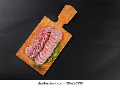 saveloy sausage slices on cutting board topview