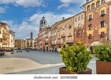 Savigliano, Cuneo, Piedmont, Italy - September 2, 2021: Piazza Santarosa with the civic tower, main square with historic buildings of medieval origin