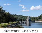 Saville Dam and Barkhamsted Reservoir in Barkhamsted, Connecticut, USA on the eastern branch of the Farmington River with Saville Dam Tower with stone Roman arch bridge walkway