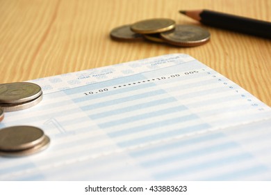 Saving account from bank with coins and pencil on the table for financial and loan - Shutterstock ID 433883623
