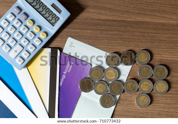 Saving account passbook with calculator and car\
made by coins